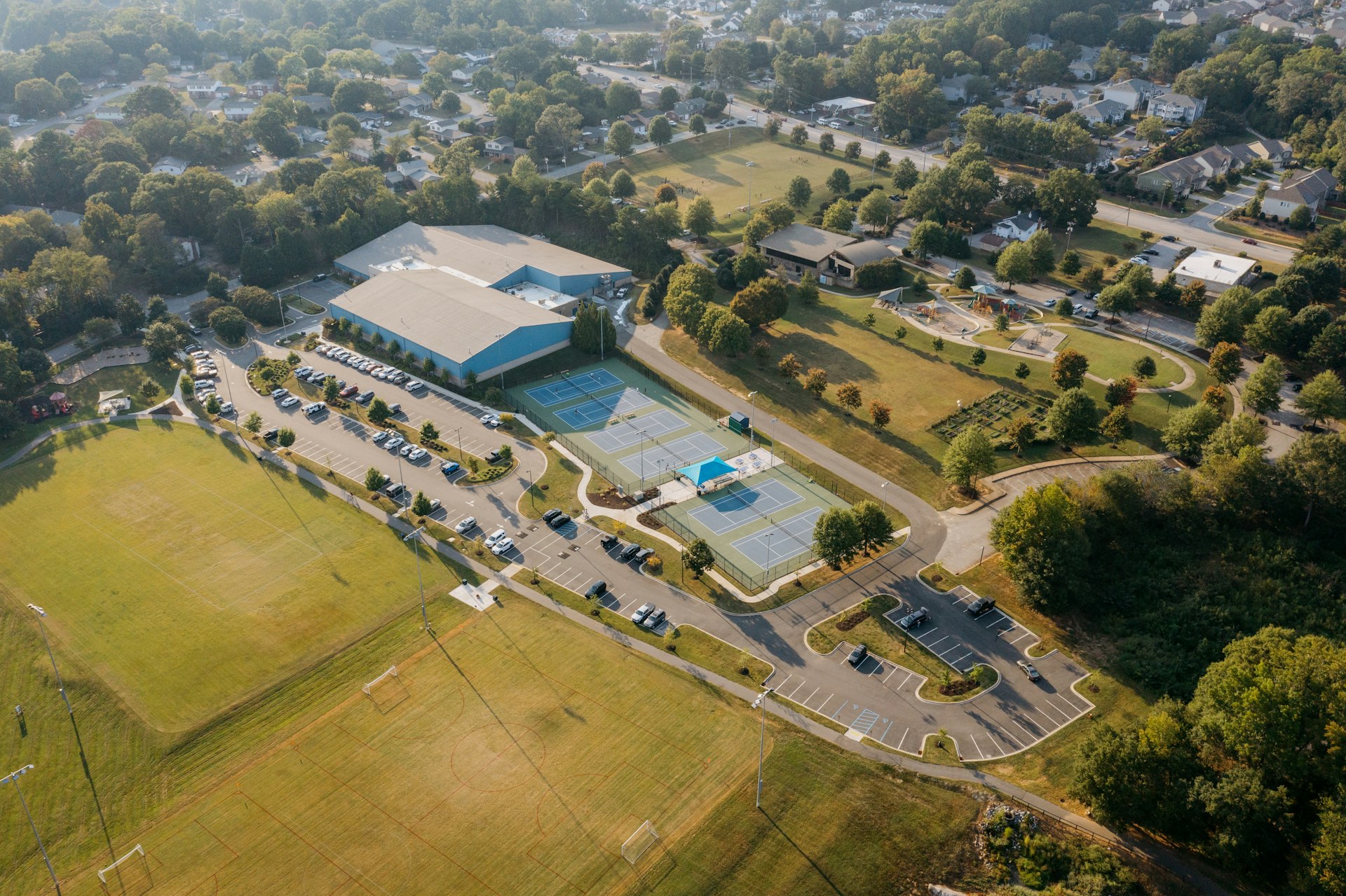Aerial view of a sports complex with courts and fields.